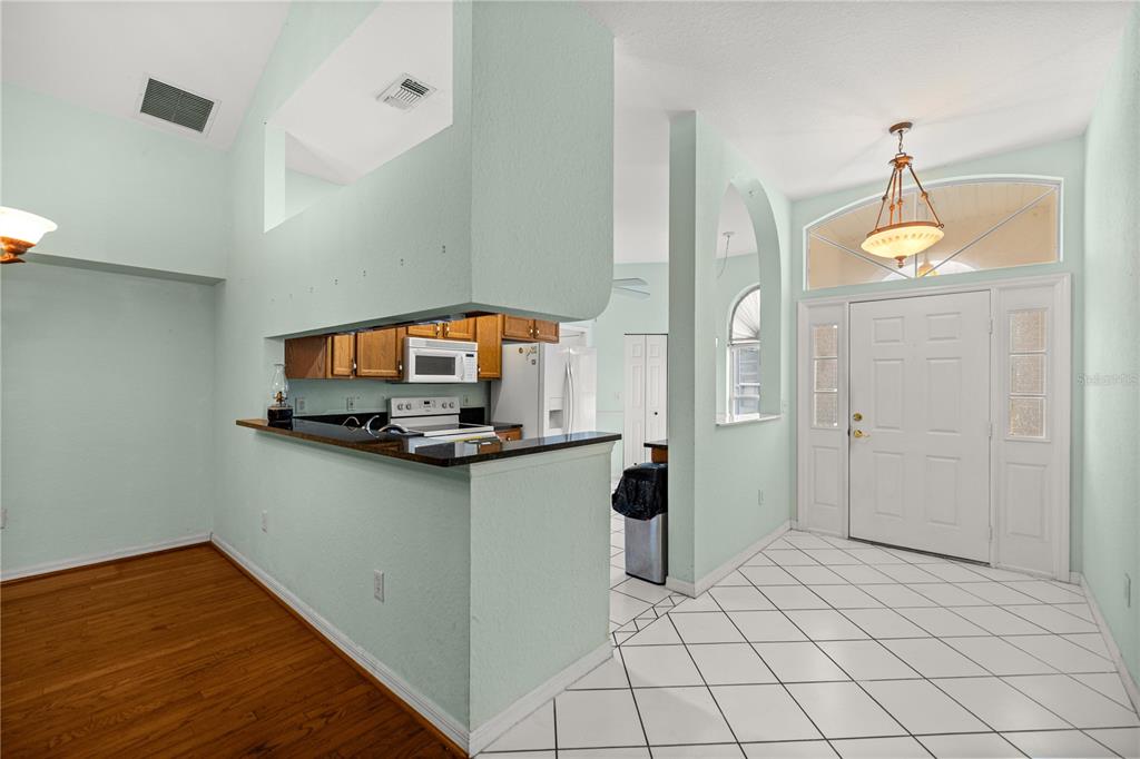 10891 Southwest 69th Circle Ocala, FL 34476 - Photo 10 of 28 a kitchen with granite countertop a sink cabinets and stainless steel appliances