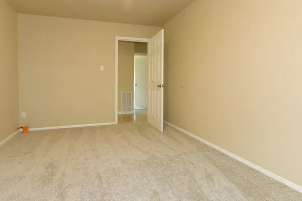 a view of a hallway with a room and a bathroom