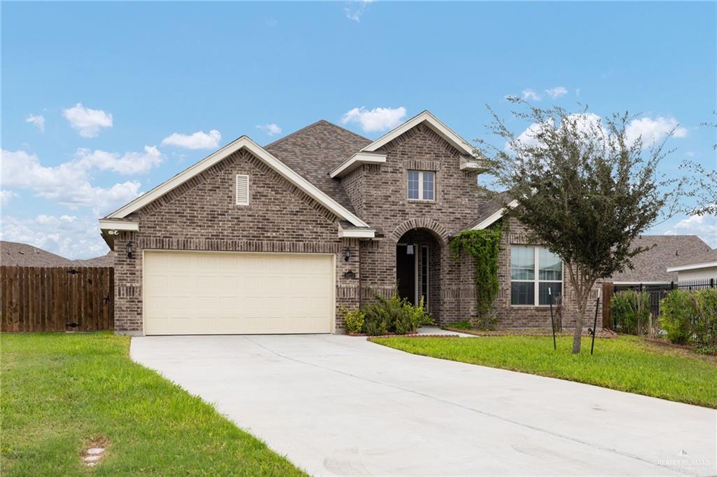 14213 Gorman Fls Road McAllen, TX 78504 - Photo 1 of 13 a front view of a house with a garden and garage