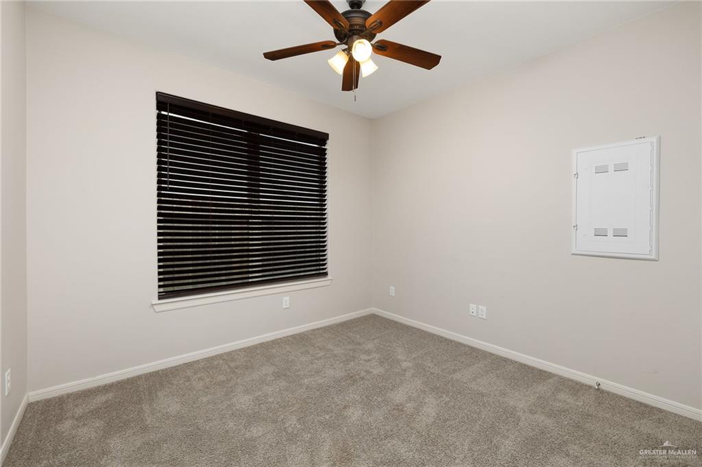 14213 Gorman Fls Road McAllen, TX 78504 - Photo 12 of 13 an empty room with windows and a ceiling fan