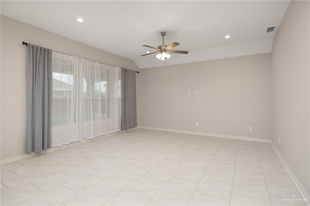 14213 Gorman Fls Road McAllen, TX 78504 - Photo 3 of 13 an empty room with chandelier fan