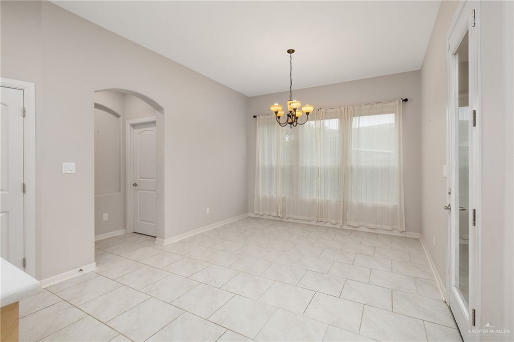 14213 Gorman Fls Road McAllen, TX 78504 - Photo 5 of 13 a view of an empty room and chandelier fan
