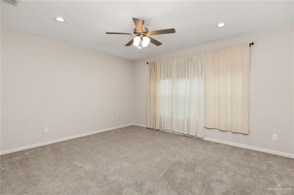 14213 Gorman Fls Road McAllen, TX 78504 - Photo 6 of 13 an empty room with fan and windows