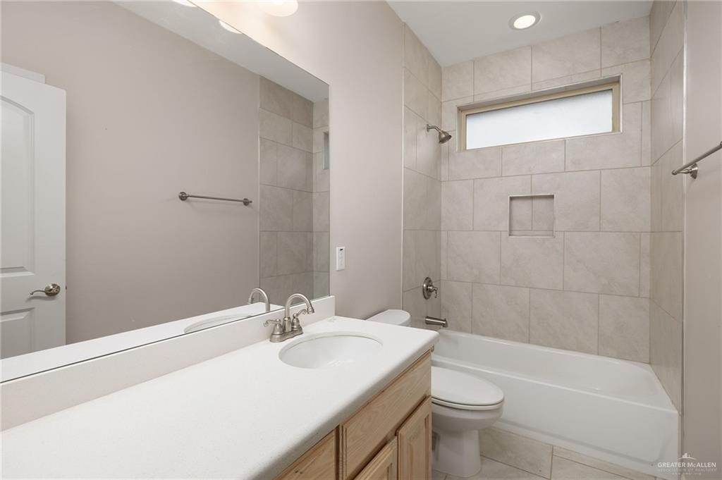 14213 Gorman Fls Road McAllen, TX 78504 - Photo 10 of 13 a bathroom with a sink a toilet and shower