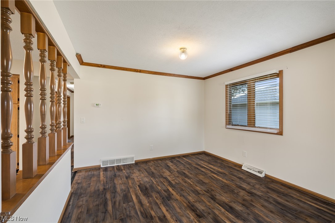 14495 Sheldon Road Cleveland, OH 44130 - Photo 11 of 27 Unfurnished room with crown molding and dark hardwood / wood-style floors