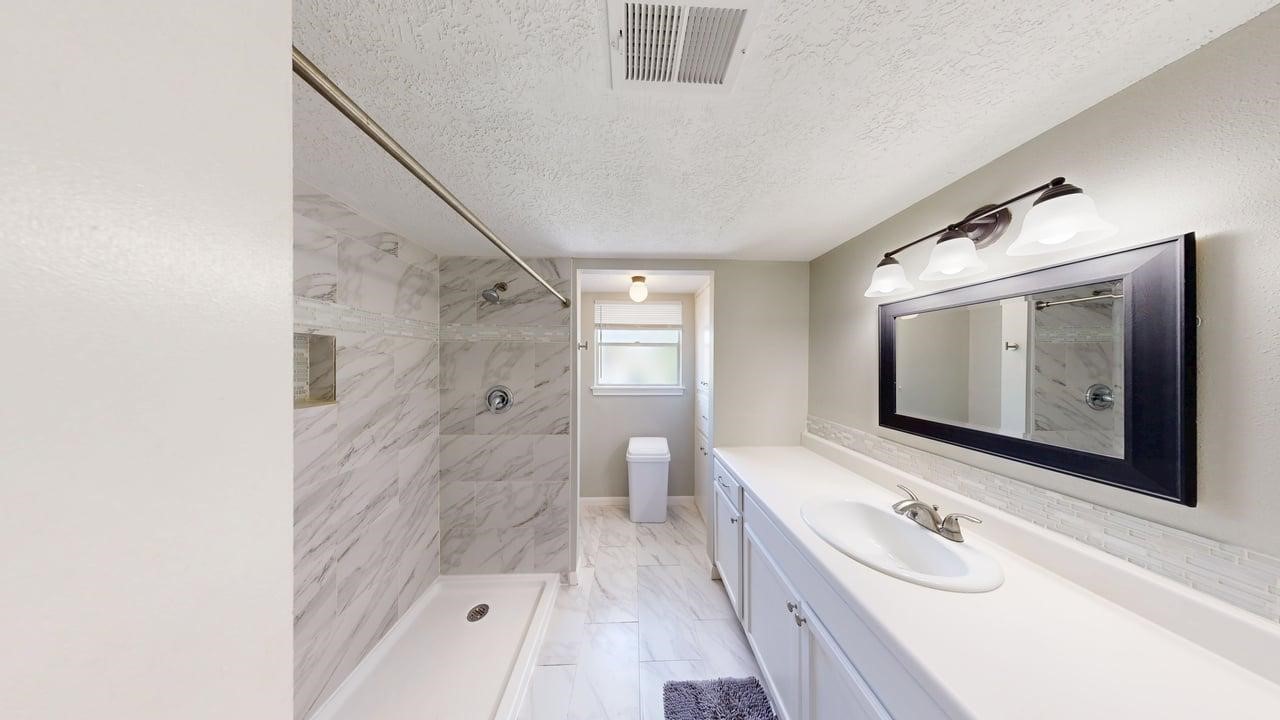 619 Cotter Drive Spring, TX 77373 - Photo 40 of 50 a bathroom with a double vanity sink and mirror with shower