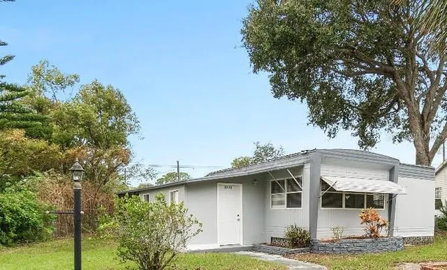 a front view of a house with a garden