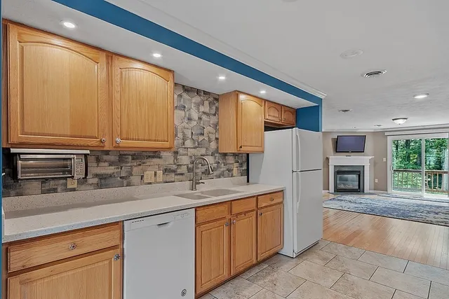 a kitchen with stainless steel appliances granite countertop a refrigerator sink and cabinets
