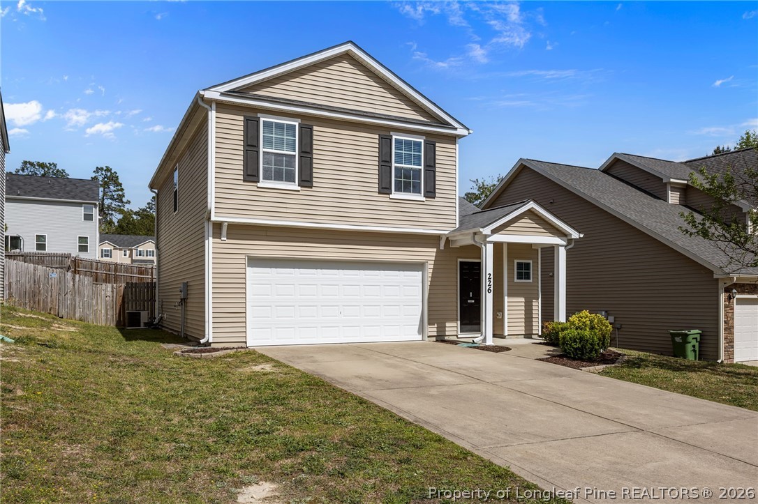 226 River Oak Street Spring Lake, NC 28390 - Photo 2 of 41 a front view of a house with a yard and garage