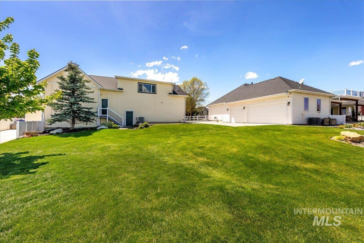 414 East Shafer View Drive Meridian, ID 83642 - Photo 37 of 50 Expansive green lawn with mature trees and landscaping, Full auto sprinklers on pressurized irrigation, fully fenced yard, Easy to maintain landscaping