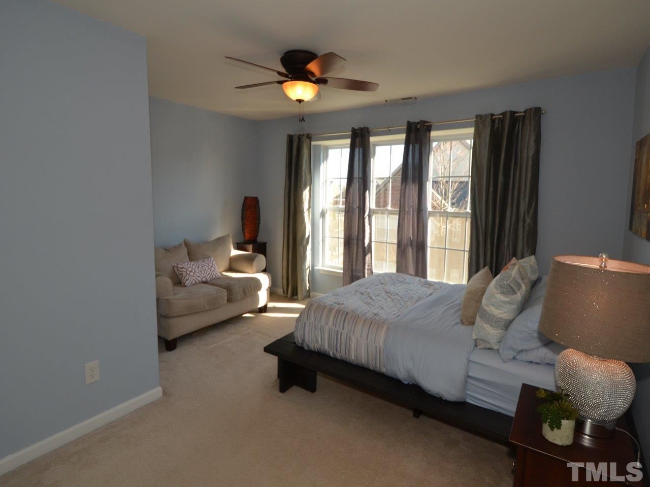 9705 Raya Court Raleigh, NC 27617 - Photo 12 of 25 a living room with furniture and a large window