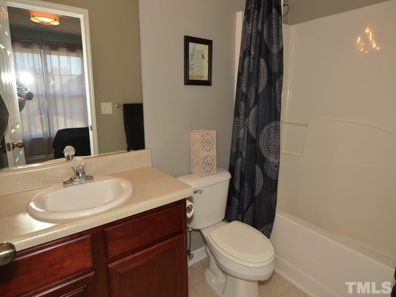 9705 Raya Court Raleigh, NC 27617 - Photo 17 of 25 a bathroom with a sink a toilet and vanity