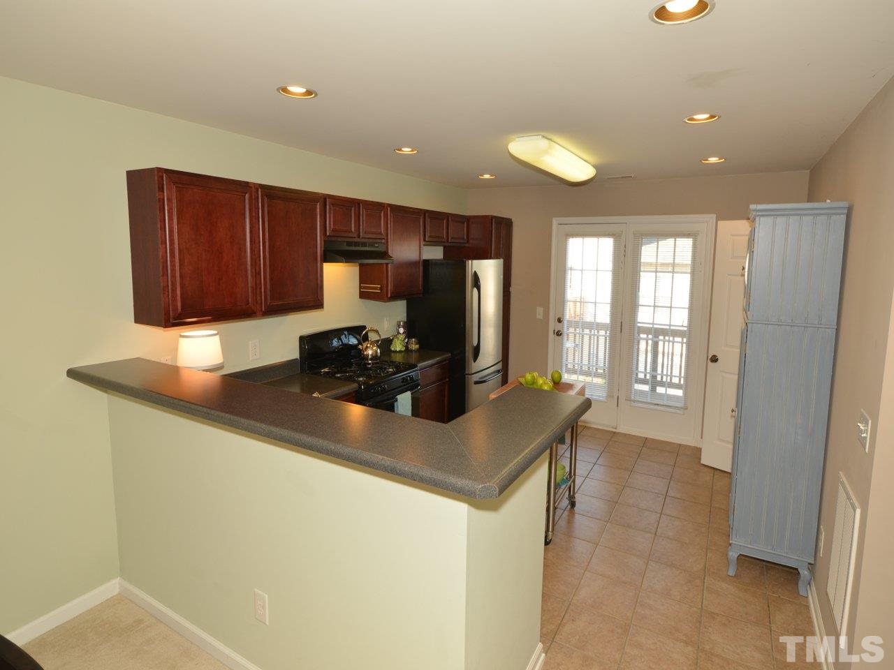9705 Raya Court Raleigh, NC 27617 - Photo 5 of 25 a kitchen with stainless steel appliances granite countertop a sink a stove and a refrigerator