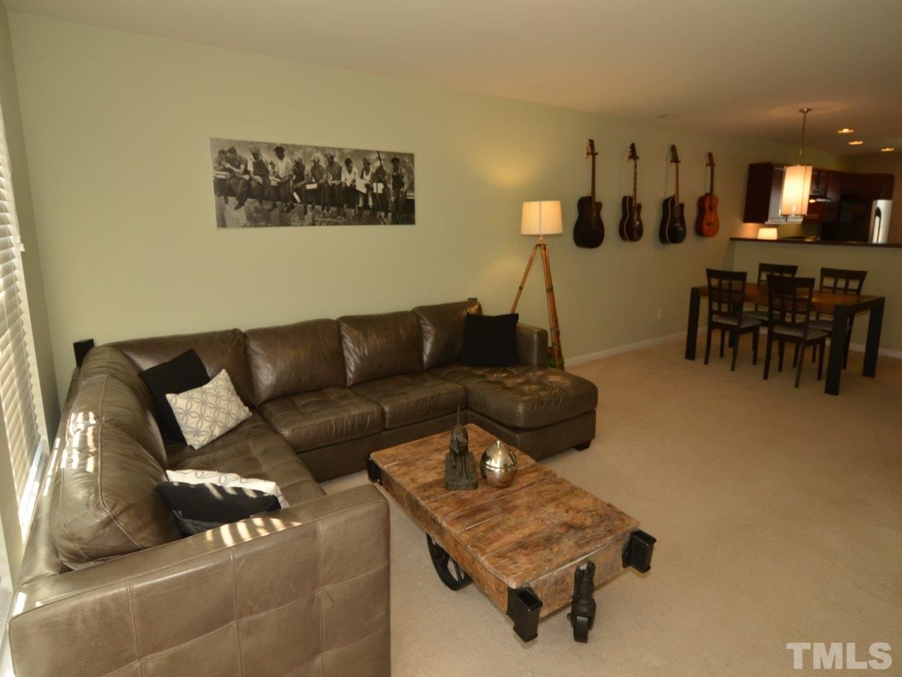 9705 Raya Court Raleigh, NC 27617 - Photo 8 of 25 a living room with furniture and a dining table with kitchen view