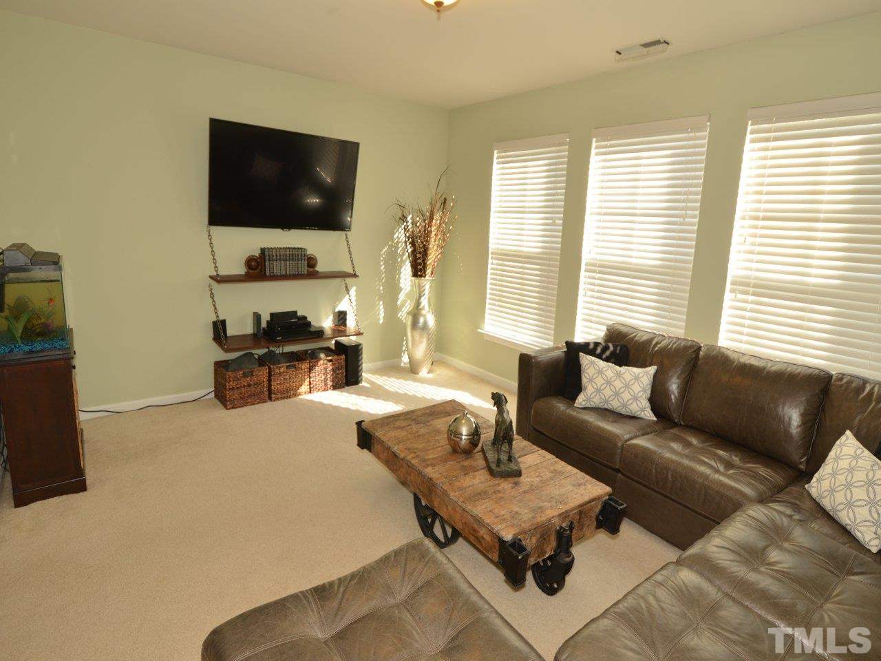 9705 Raya Court Raleigh, NC 27617 - Photo 10 of 25 a living room with furniture and a flat screen tv
