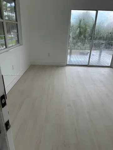 a view of an empty room with a glass door