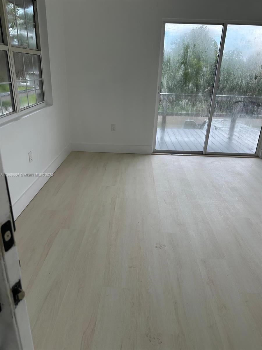 420 Burning Tree Lane, Unit 420 Punta Gorda, FL 33982 - Photo 15 of 19 a view of an empty room with a glass door