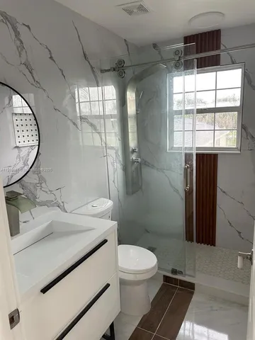 a bathroom with a sink toilet and shower