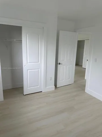 an empty room with closet area