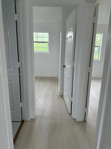 an empty room with windows and closet