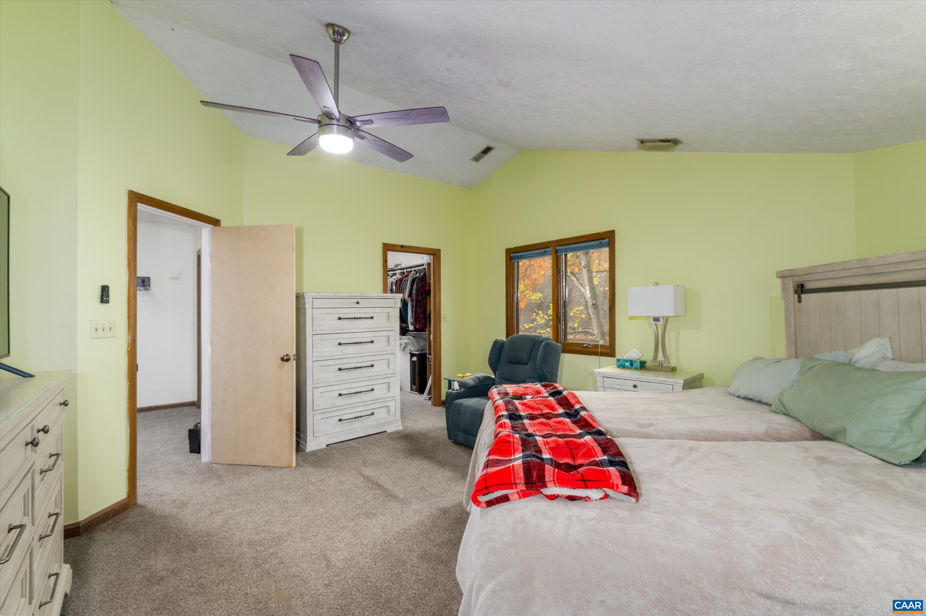 41 Dogleg Road Palmyra, VA 22963 - Photo 30 of 47 a bedroom with a bed and a chandelier