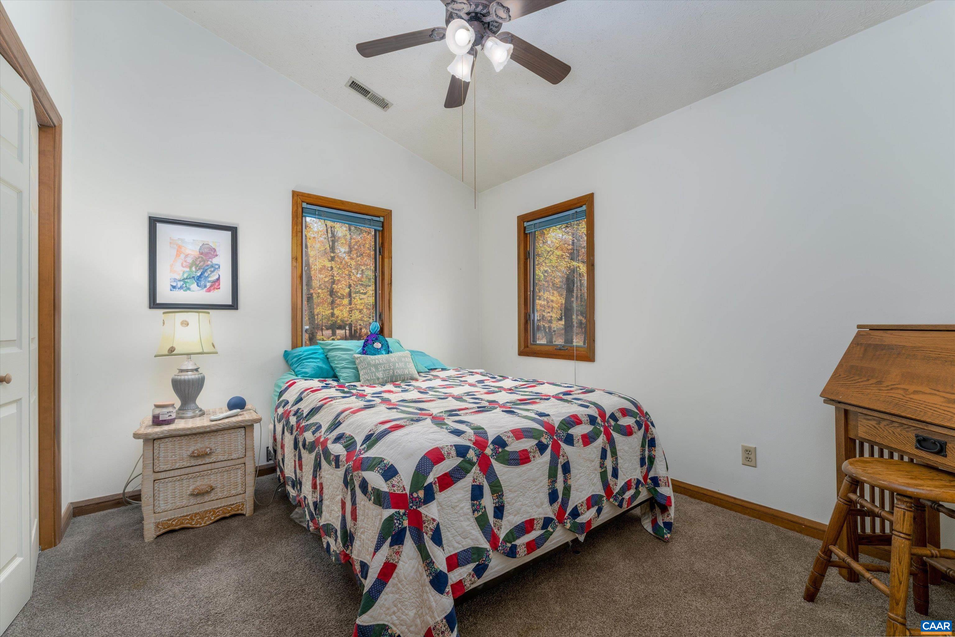 41 Dogleg Road Palmyra, VA 22963 - Photo 35 of 47 a bedroom with a bed and a chandelier