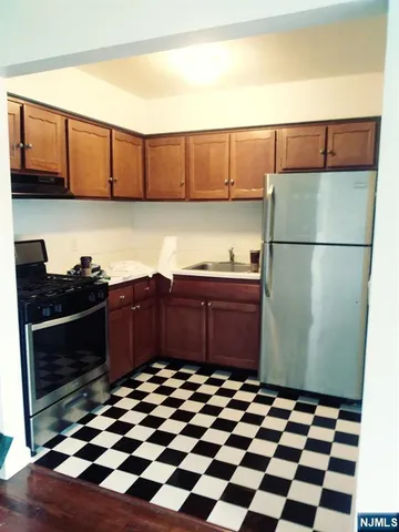 a kitchen with a refrigerator and cabinets