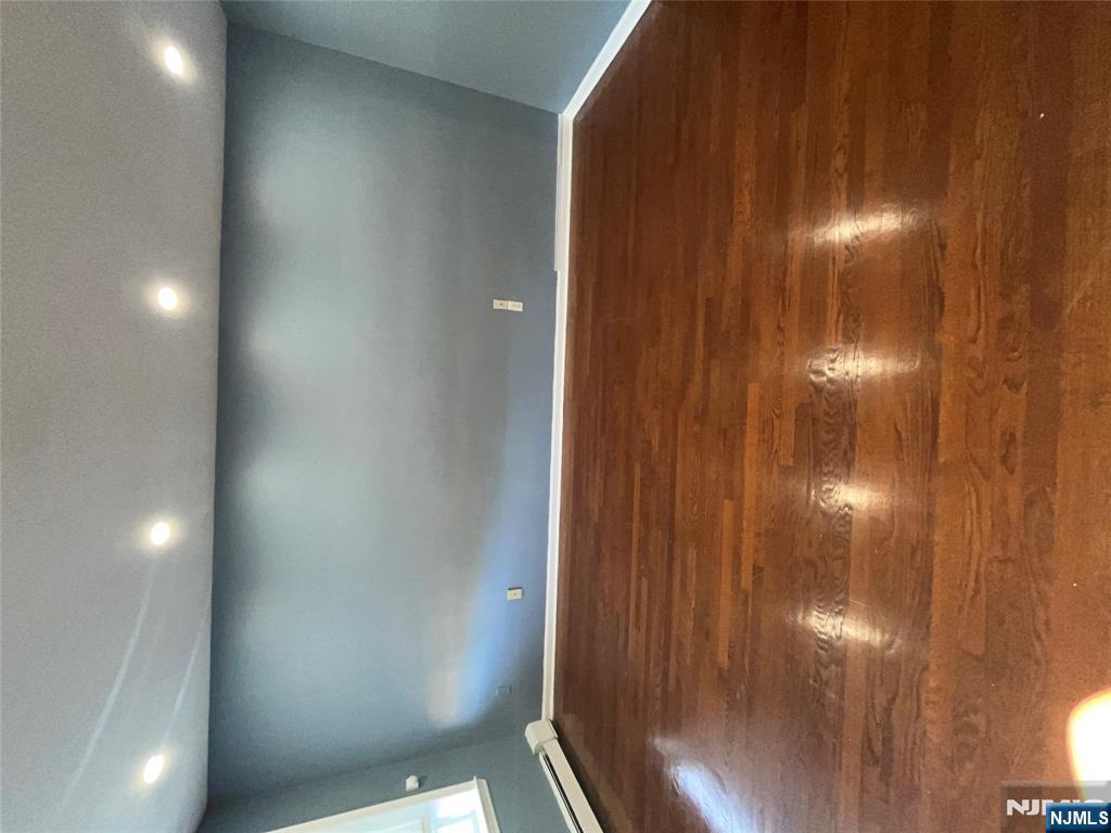 565 Grove, Unit B12 Clifton, NJ 07013 - Photo 19 of 19 a view of an empty room with wooden floor