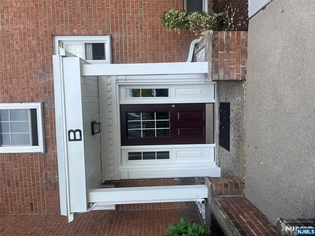 565 Grove, Unit B12 Clifton, NJ 07013 - Photo 2 of 19 a front view of a house with a yard