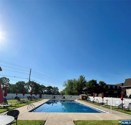 a view of yard with swimming pool and seating