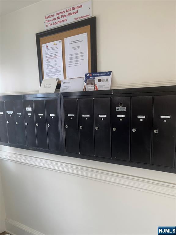 565 Grove, Unit B12 Clifton, NJ 07013 - Photo 9 of 19 a bathroom with a granite countertop sink vanity and mirror
