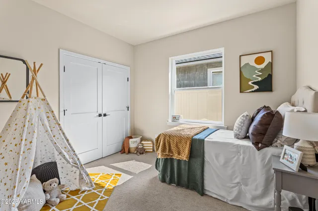 a bedroom with a bed and the view of kitchen