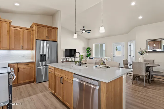 a kitchen with stainless steel appliances granite countertop a sink stove and refrigerator