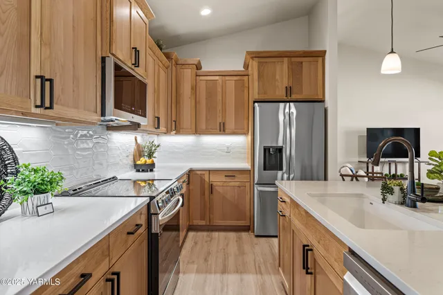 a kitchen with a sink stove and refrigerator