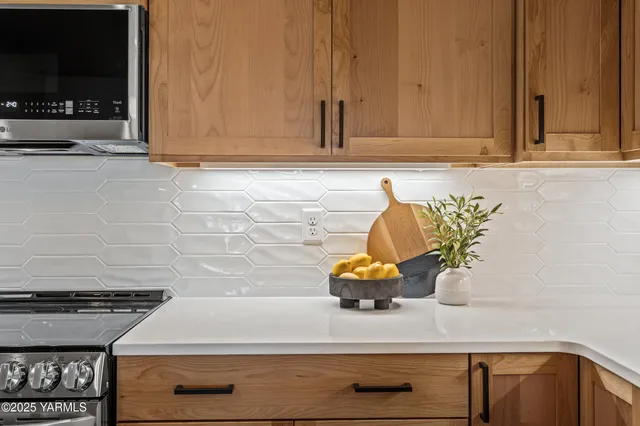 a kitchen with a stove and a white cabinet