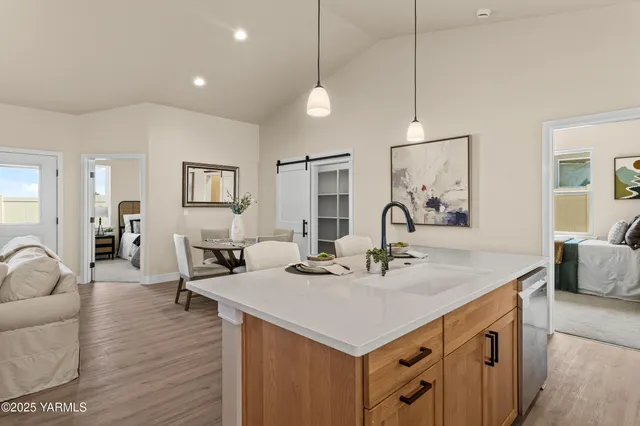 a view of living room kitchen island with furniture and wooden floor