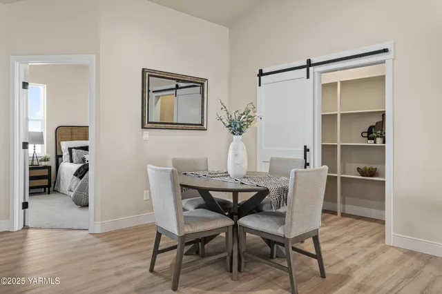 a view of a dining room with furniture and wooden floor