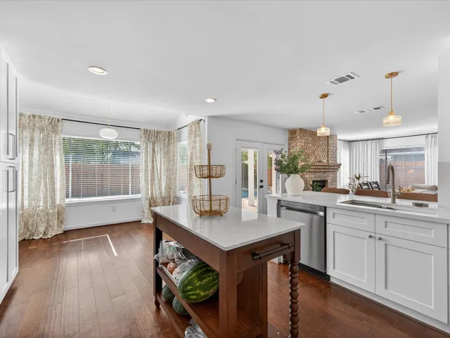 a open kitchen with sink cabinets and wooden floor