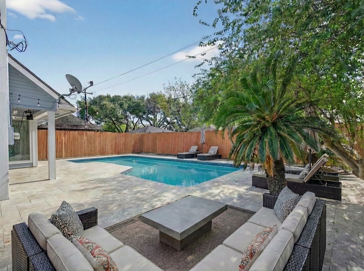 1676 Beaconshire Houston, TX 77077 - Photo 16 of 28 swimming pool with outdoor seating and green space