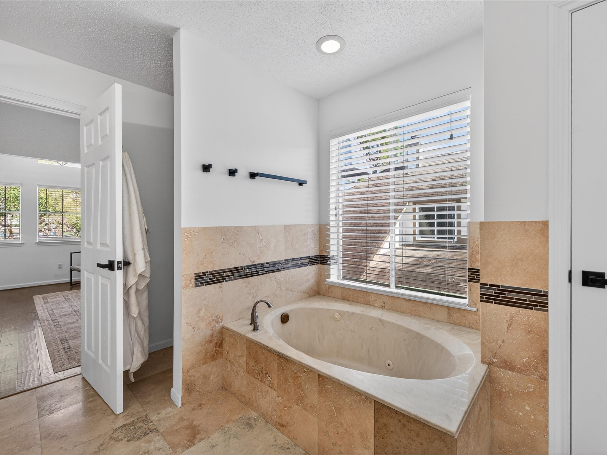1676 Beaconshire Houston, TX 77077 - Photo 21 of 28 a bathroom with a bathtub and a shower
