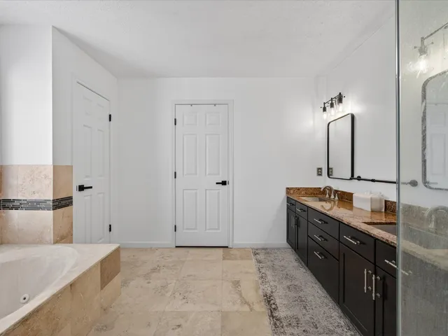 a bathroom with a bathtub and a shower