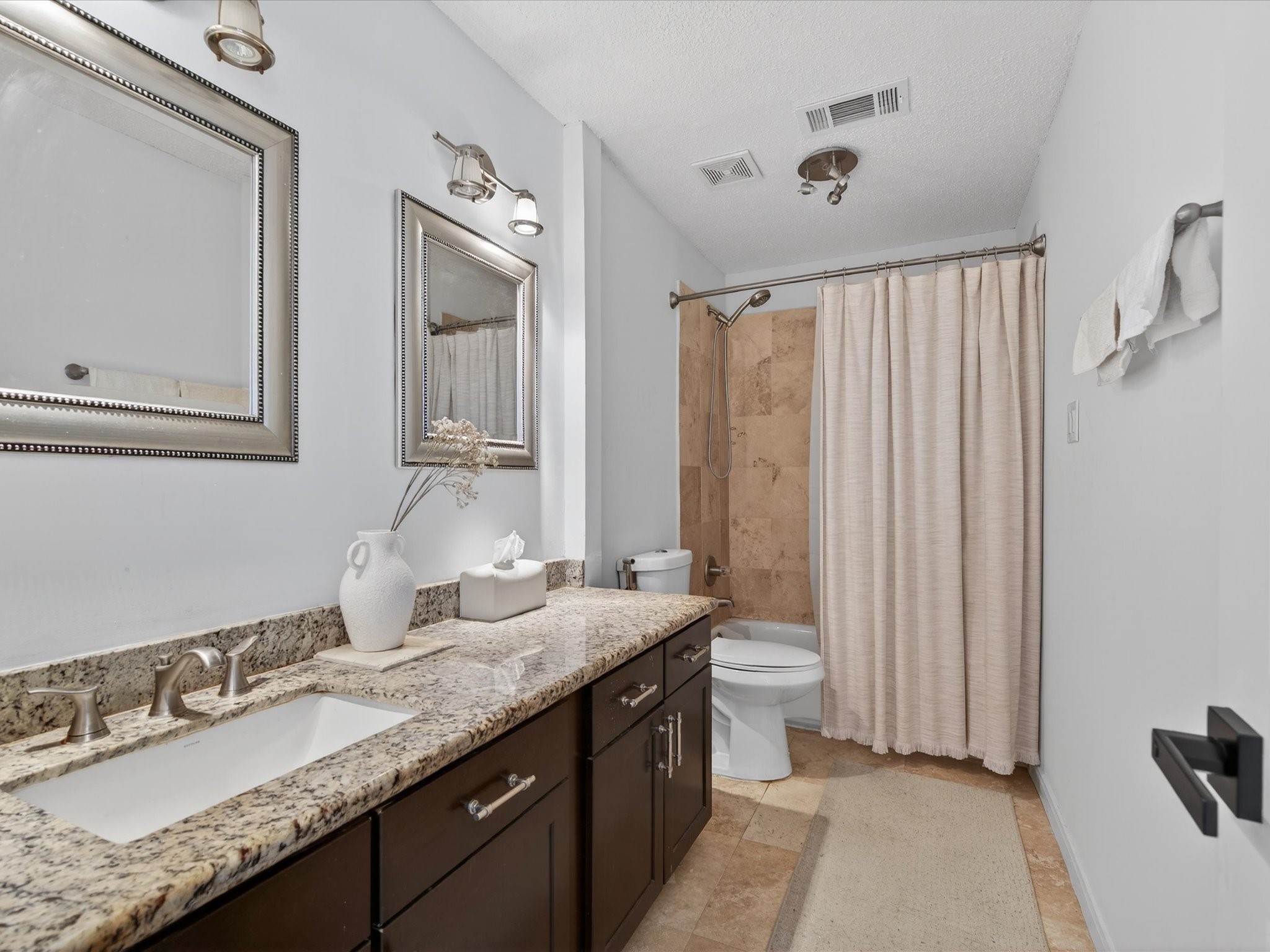 1676 Beaconshire Houston, TX 77077 - Photo 24 of 28 a bathroom with double vanity sinks and a mirror