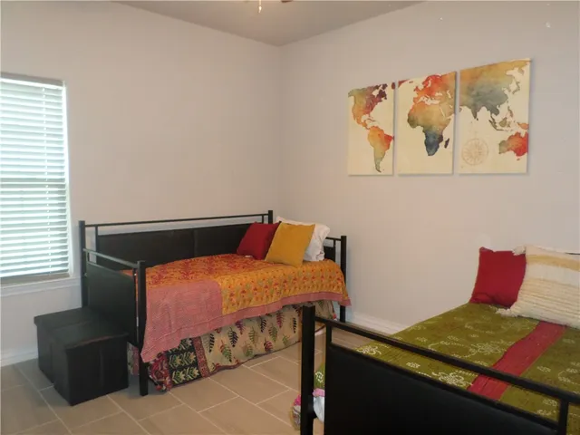 a bedroom with a bed and wall paintings