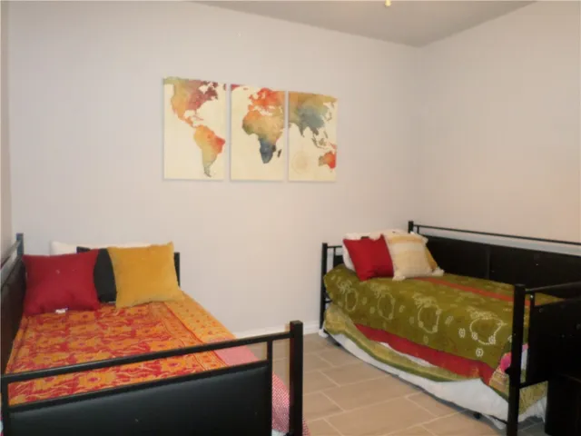 a bedroom with a bed and wall painting