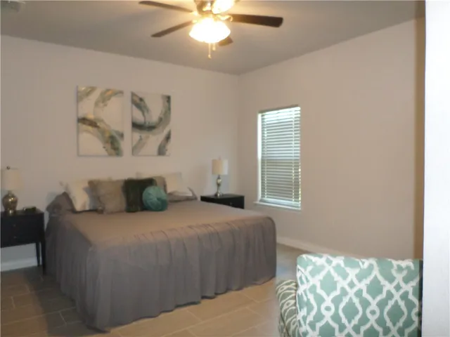 a bedroom with a bed and a couch