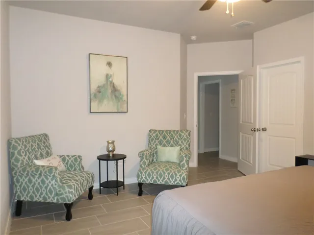 a bathroom with a granite countertop toilet sink and mirror