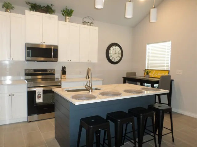 a kitchen with a table and chairs