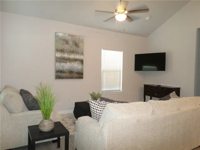 a bedroom with a bed window and a chair