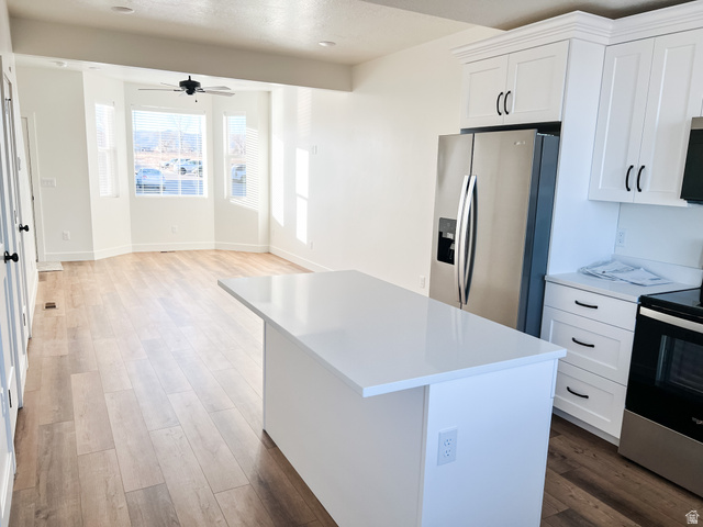 522 West 2000 South Vernal, UT 84078 - Photo 14 of 18 Kitchen with stainless steel appliances, white cabinets, dark wood finished floors, a center island, and ceiling fan