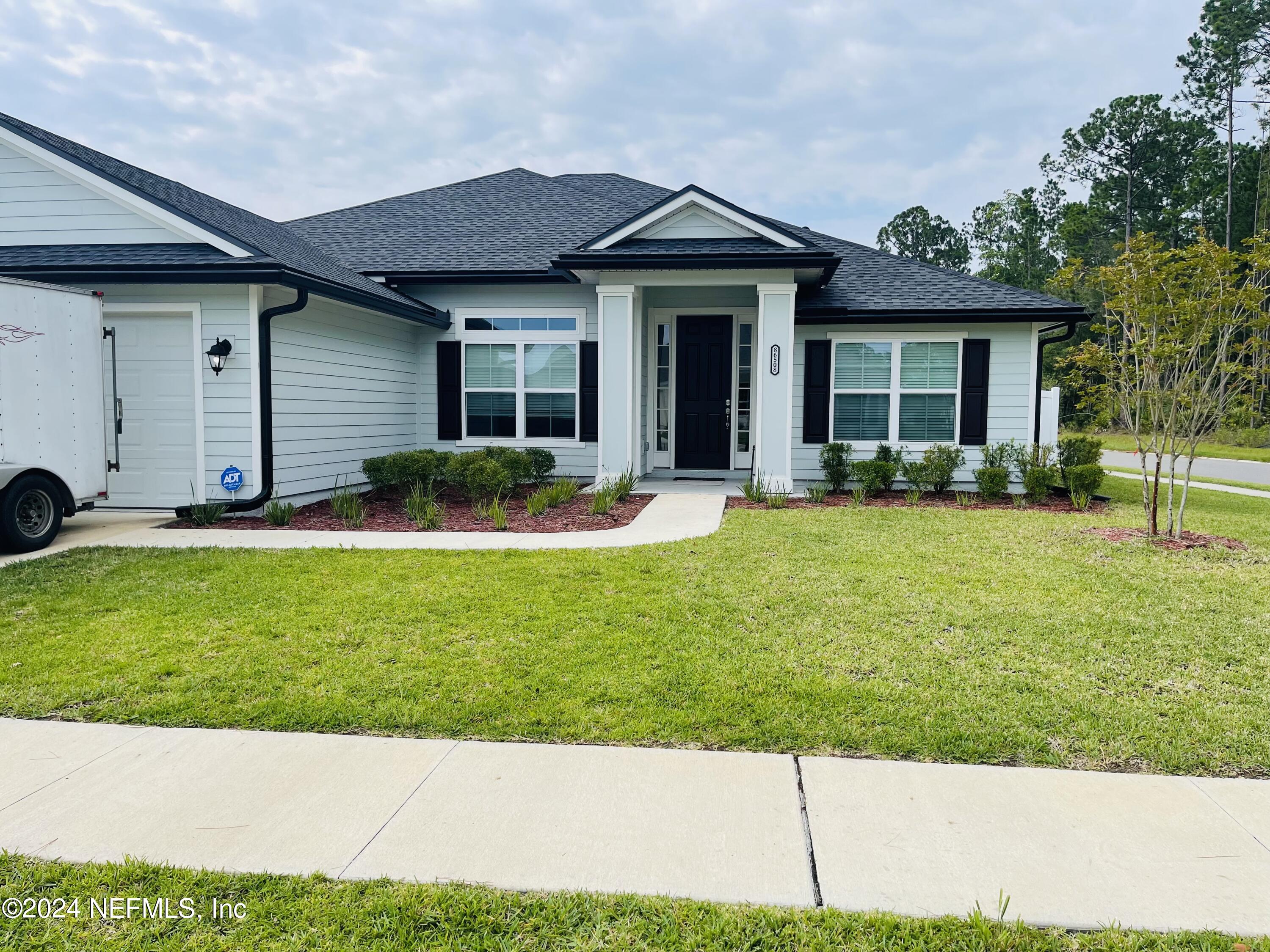 a front view of a house with a yard and porch